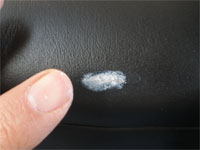 applying leather filler to scuff