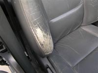 scuffed leather car seat