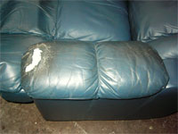 an example of a ripped recliner chair torn leather